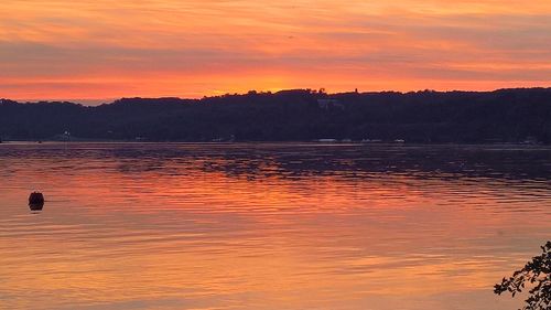 Scenic view of lake against romantic sky at sunset