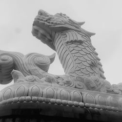 Low angle view of statue against building