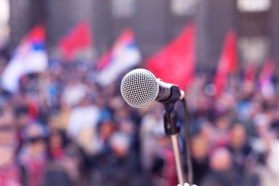 Close-up of microphone against crowd