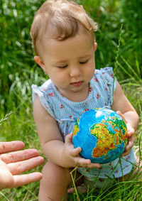 Portrait of cute baby girl playing with easter egg