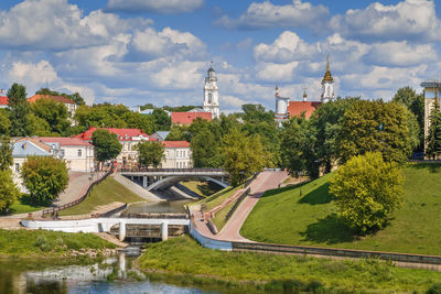 Panoramic view of buildings and trees against sky