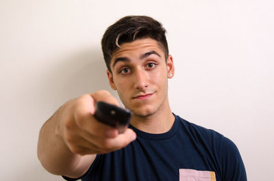 Portrait of young man against white background