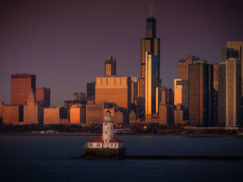 Chicago lighthouse at blue hour with skyscrapers in background aerial vie