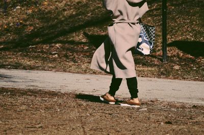 Low section of woman walking on land