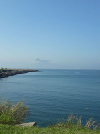 Scenic view of sea against clear blue sky