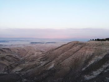 Scenic view of desert against sky during sunset