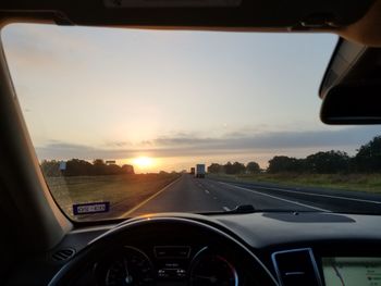 Cars on road seen through car windshield