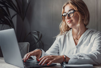 Portrait of woman using laptop while sitting in car