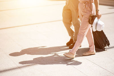 Low section of woman walking on street