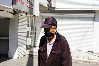 Full length of man standing against building in city