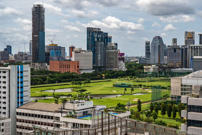 Buildings in city against cloudy sky