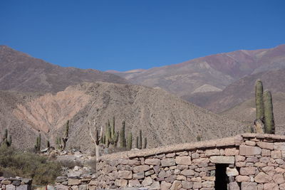 Scenic view of mountains against clear blue sky