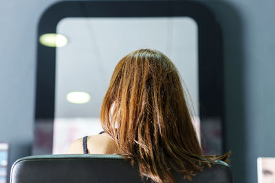 Rear view of woman using mobile phone