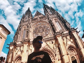 Low angle view of man and buildings against sky