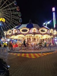 Illuminated ferris wheel at night