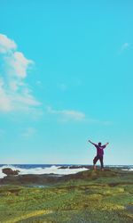 Rear view of woman standing on beach