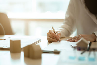 Midsection of woman working on table