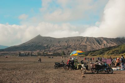 Panoramic view of people on landscape against sky