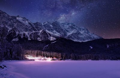 Scenic view of mountains against sky at night