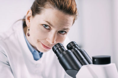 Portrait of archaeologist by microscope