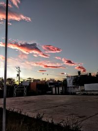 Houses against sky at sunset