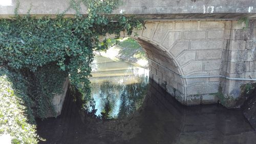 View of canal going under a stone bridge