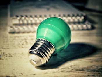 Close-up of light bulb on table