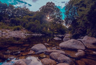 Scenic view of rocks in lake against sky