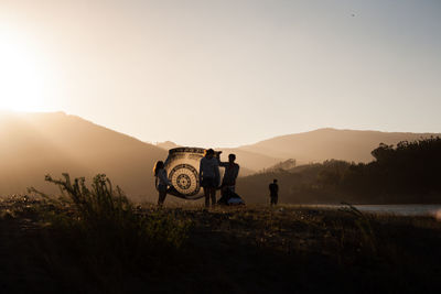 Rear view of man photographing on mountain