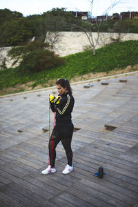 Full length of woman exercising outdoors