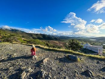 Rear view of man walking on mountain against sky on the margarita island in venezuela 