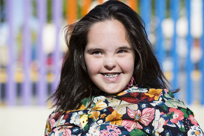 Teenager girl with down syndrome smiling, braces