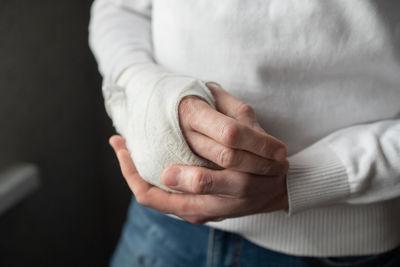 The broken hand of a man in a cast