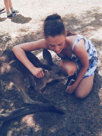 Portrait of woman embracing a kangaroo