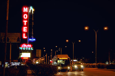 Illuminated street lights in city at night