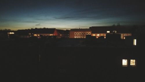 Illuminated city against sky at night