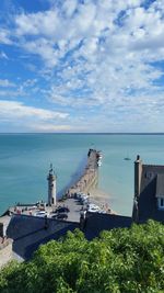 High angle view of sea and cityscape against sky