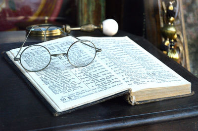Close-up of eyeglasses on open book