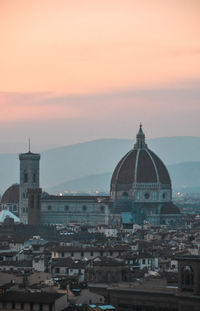 View of buildings in city at sunset