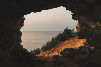 Rock formations by sea against sky