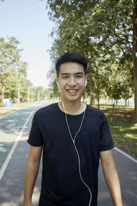 Portrait of smiling young man standing outdoors