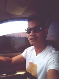 Portrait of mature man sitting in car