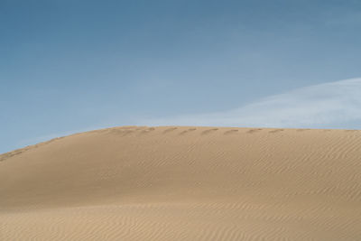 Sand dunes against sky