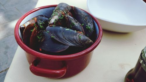 High angle view of mussels in bowl on table
