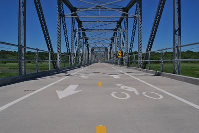 Road by bridge against clear sky