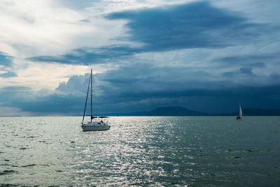 Sailboat sailing on sea against sky