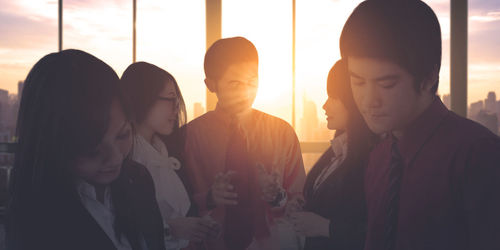 Group of people looking through window