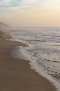 Scenic view of beach against sky during sunset