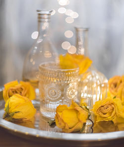 Close-up of yellow glass bottle on table