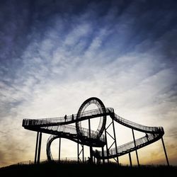 Low angle view of amusement park ride against sky